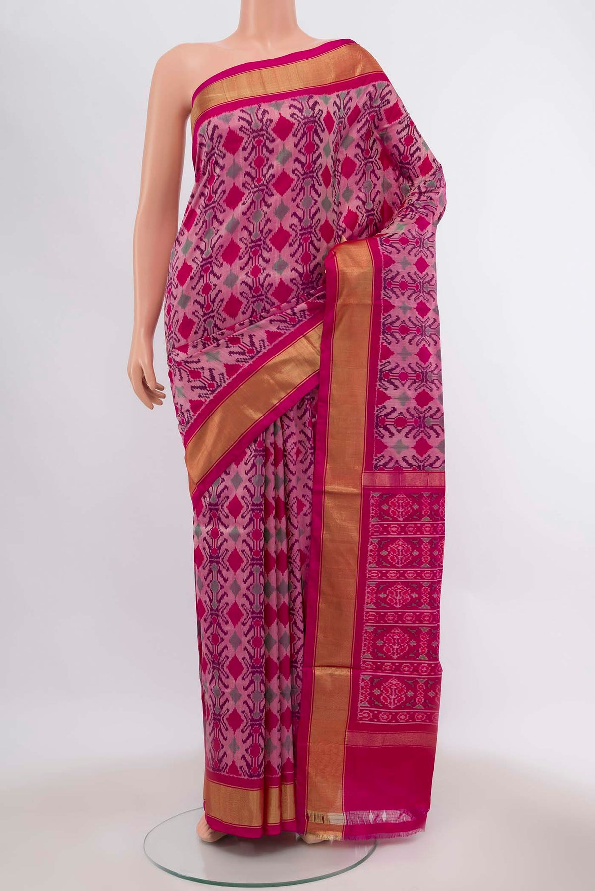 Rani Pink Pochampally Silk Saree with Ikat Print on the body and Zari Border displayed on a mannequin