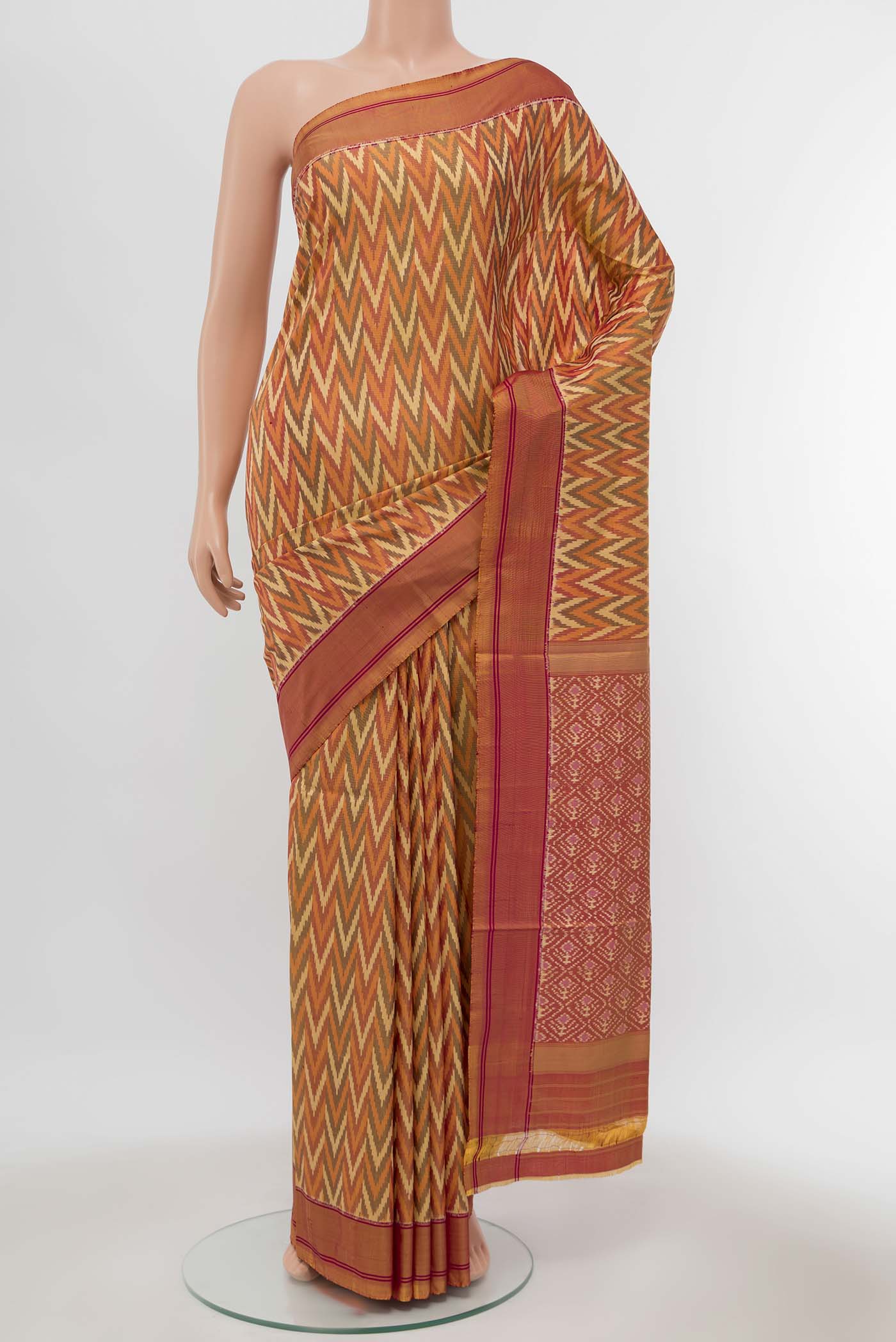 Orange Pochampally Silk Saree with Ikat Print on the body and Silk Border displayed on a mannequin