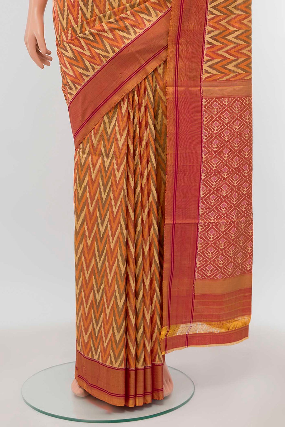 Pleats and pallu of Orange Pochampally Silk Saree with Ikat Print on the body and Silk Border