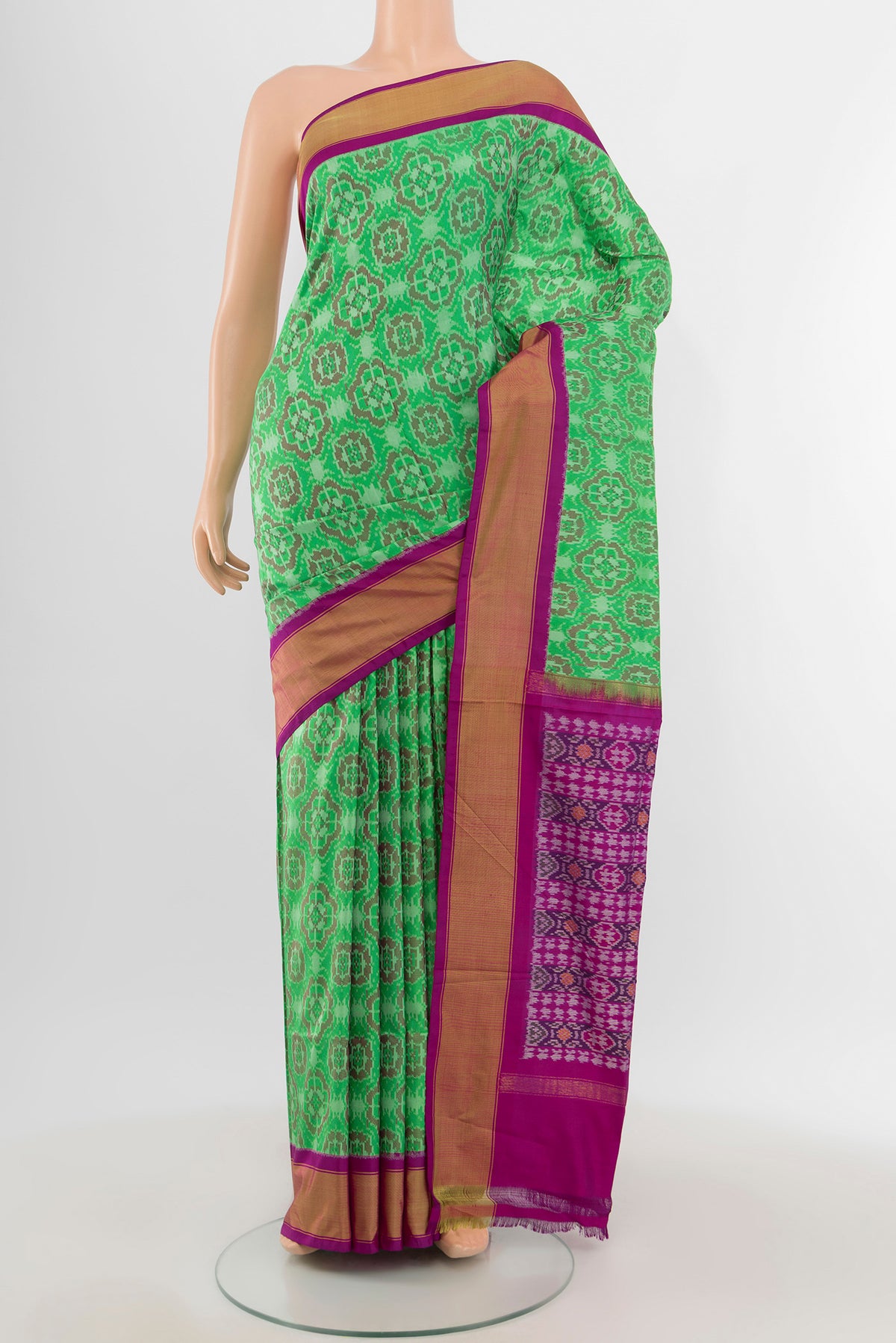 Mint Green Pochampally Silk Saree with Ikat design on the body and Zari Border.  displayed on a mannequin