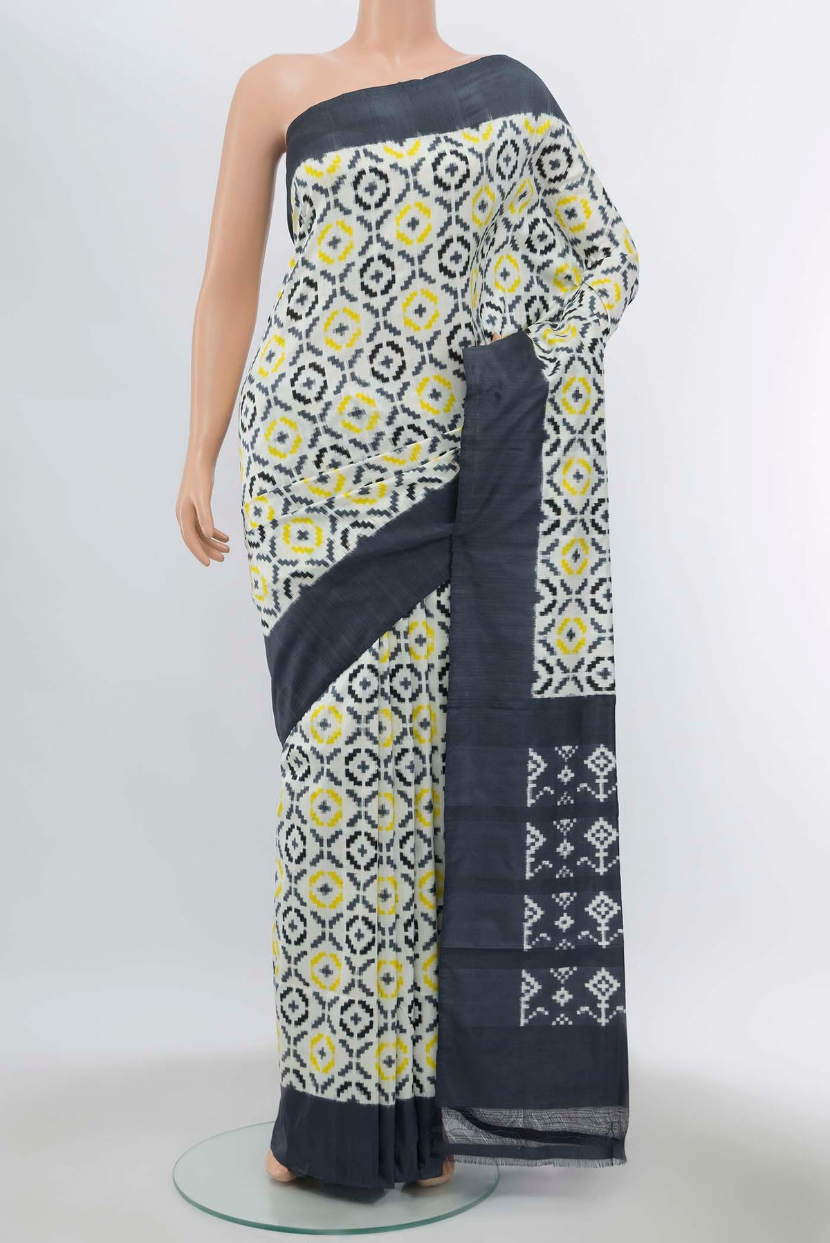 Off White Pochampally Silk Saree with Ikat Print on the body and Silk Border displayed on a mannequin