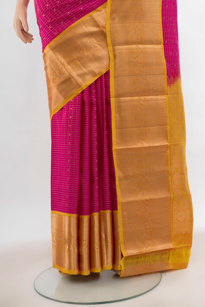 Pleats and pallu of Magenta Kanchipuram Silk Saree with Zari Butta on the body and Silk Border. 
