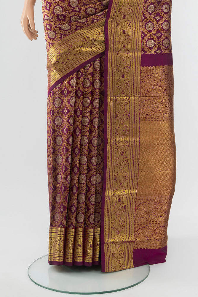 Pleats and pallu of Purple Kanchipuram Silk Saree with Zari Butta on the body and Silk Border. 
