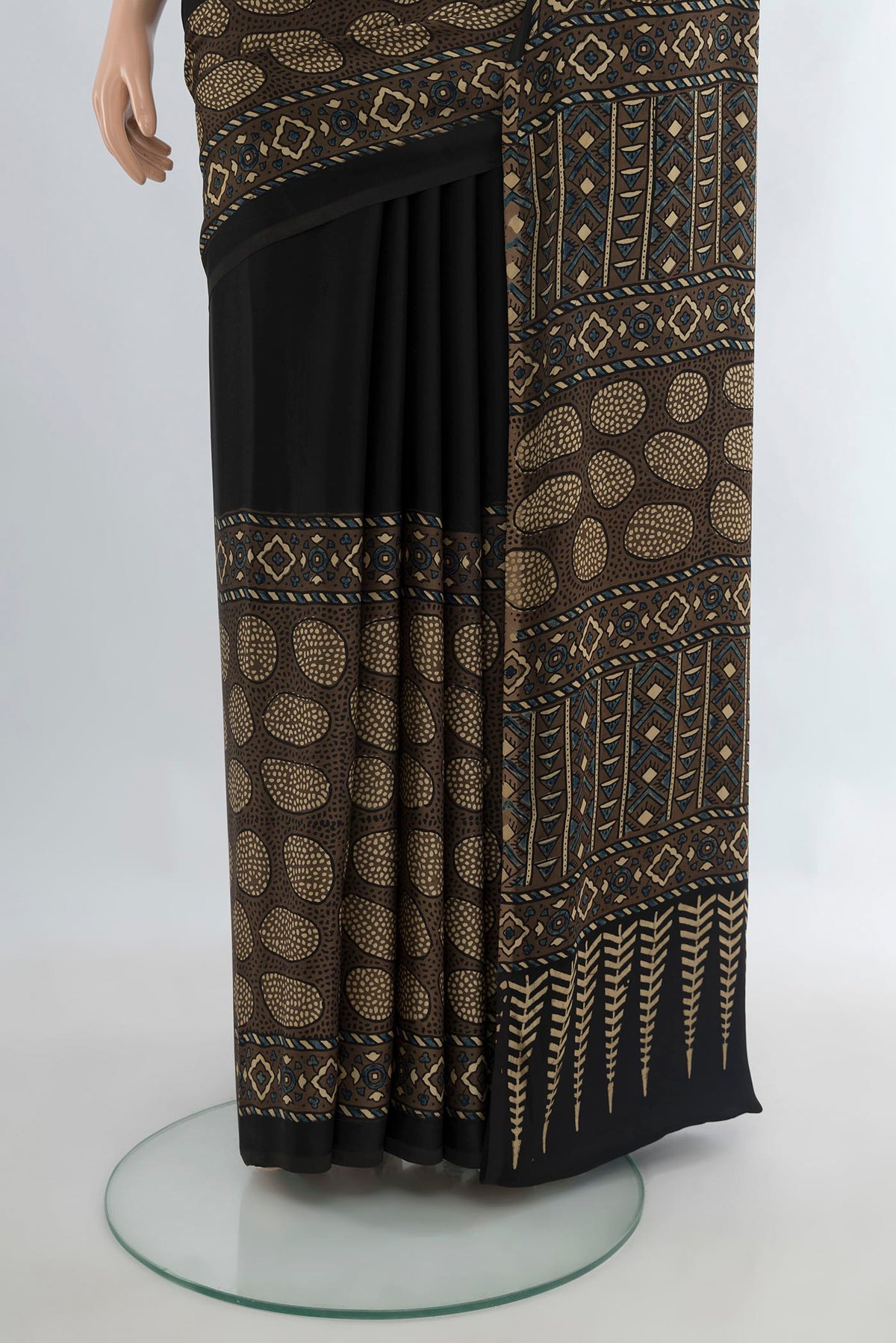 Pleats and pallu of Black Blended Satin Crepe Saree with Plain Body and Printed Border. 