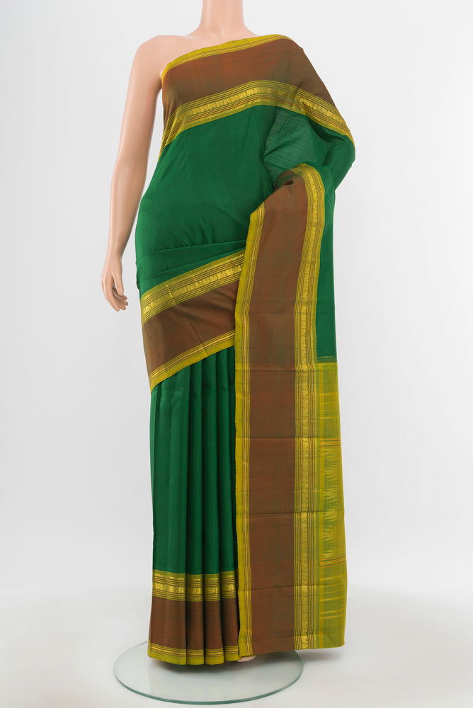 Pure Silk Pure Zari Light Green Kanchipuram Saree with Zari Butta on the body and Silk Border.  displayed on a mannequin