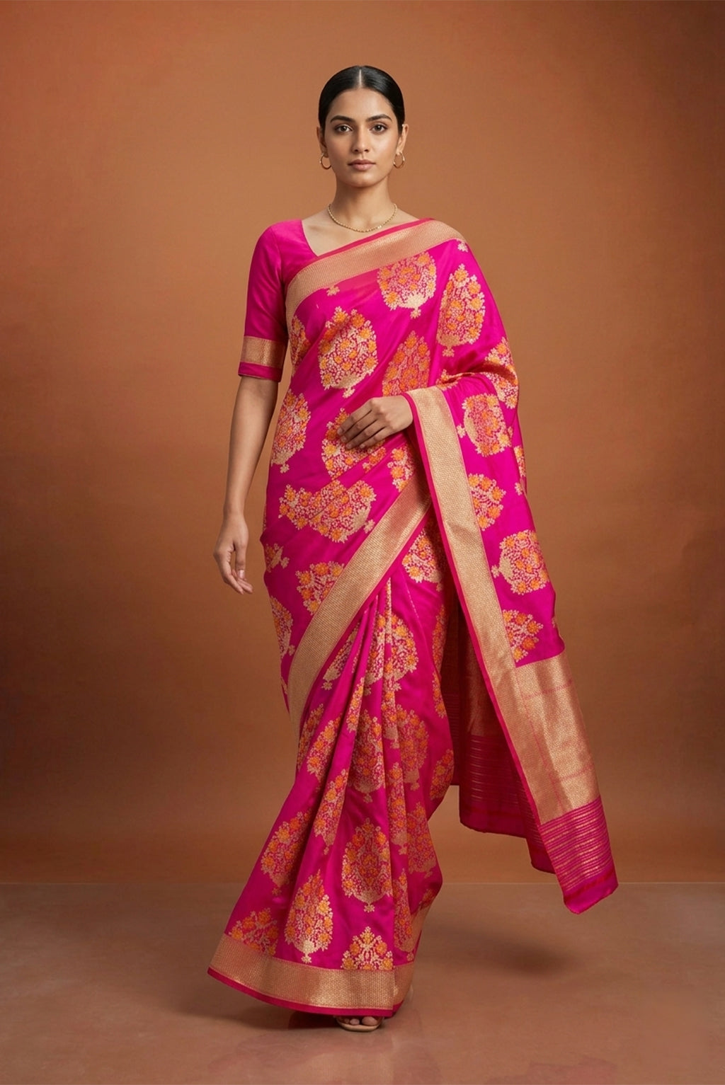 Model wearing a Pure Silk Pure Zari Rani Pink Banarasi Saree with Zari Butta on the body and Attached Border.