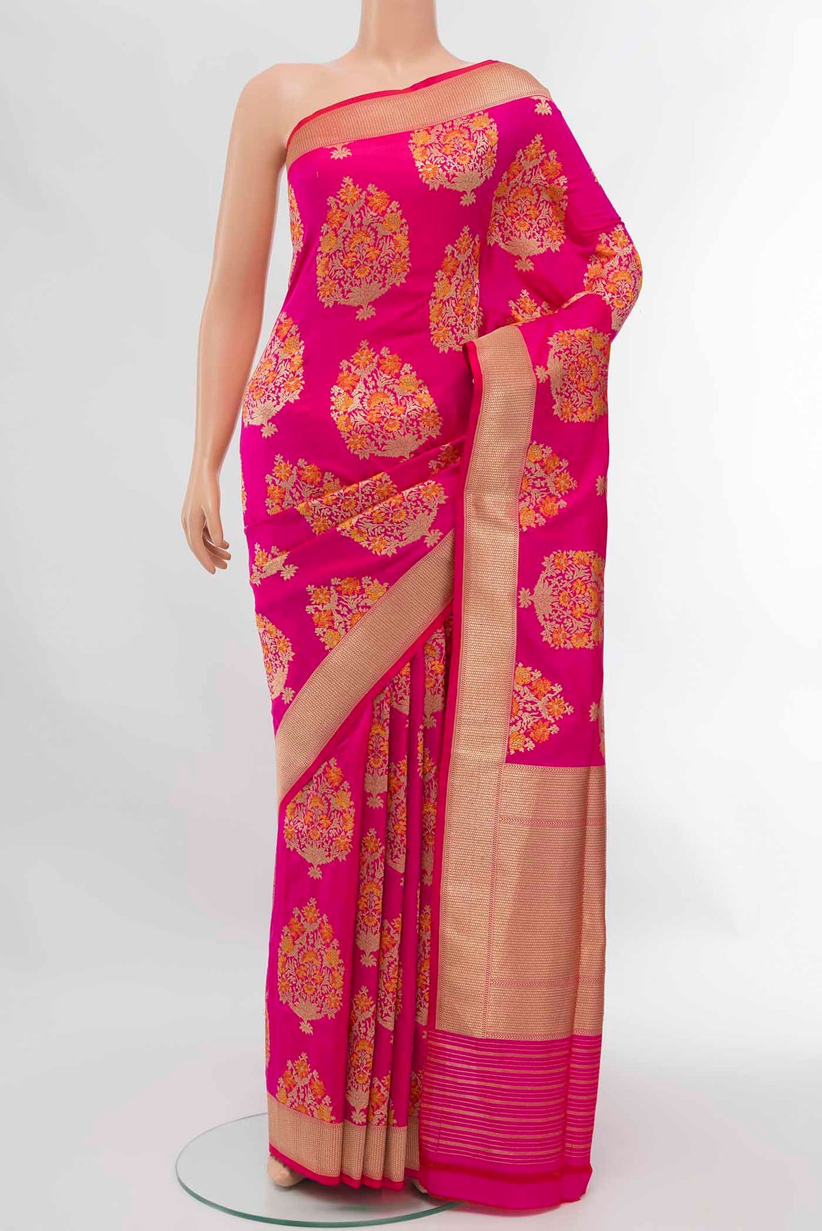 Pure Silk Pure Zari Rani Pink Banarasi Saree with Zari Butta on the body and Attached Border displayed on a mannequin