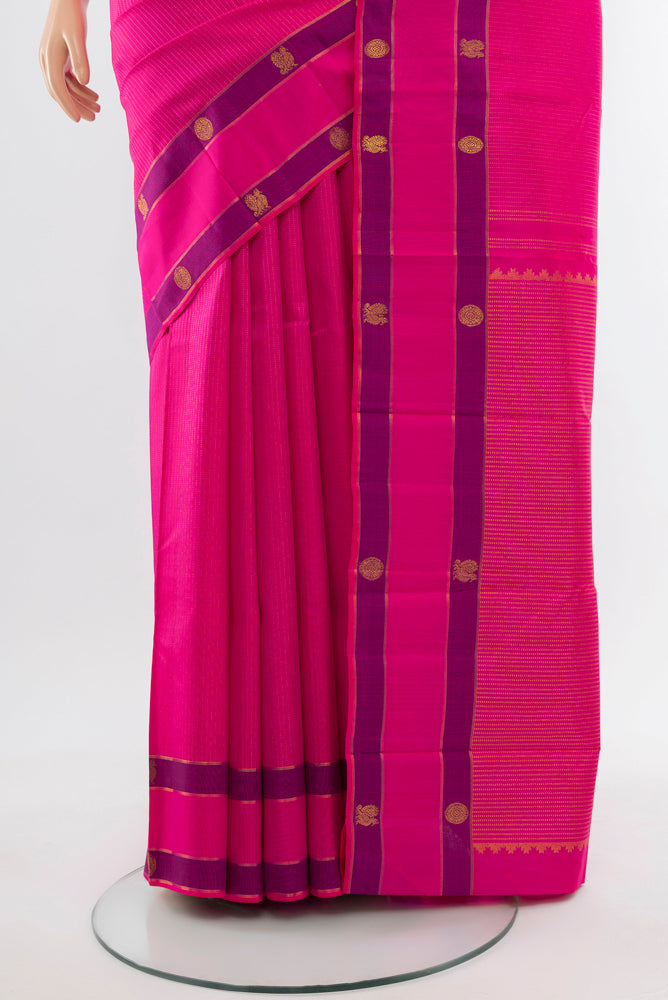 Pleats and pallu of Rani Pink Kanchipuram Silk Saree with Zari Butta on the body and Silk Border. 