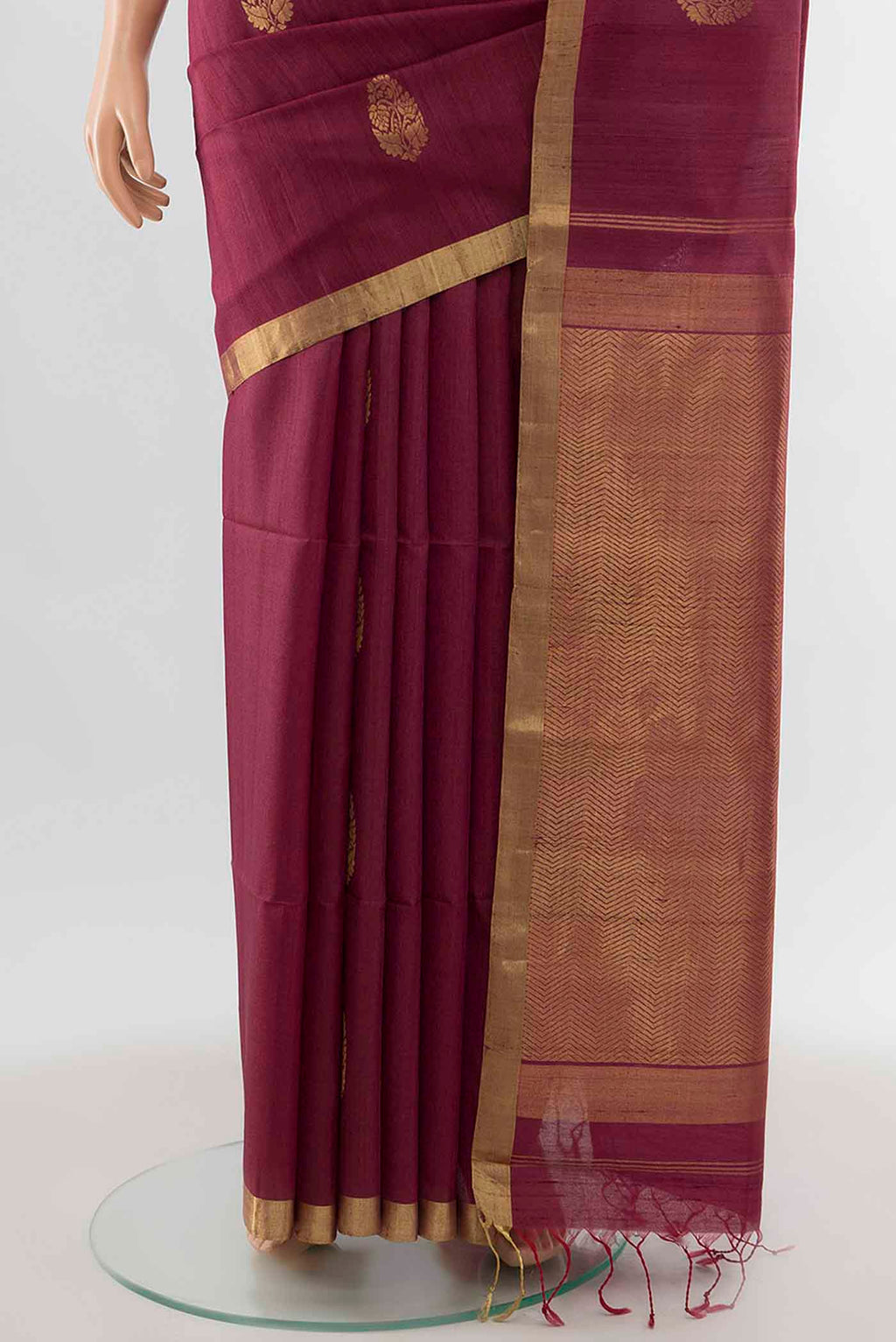 Pleats and pallu of Maroon Tussar Silk Saree with Zari Butta on the body and Silk Border