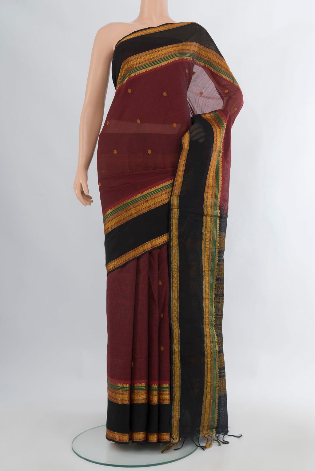 Maroon Silk Cotton Saree with Thread Butta on the body and Zari Border.  displayed on a mannequin