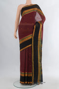 Maroon Silk Cotton Saree with Thread Butta on the body and Zari Border.  displayed on a mannequin