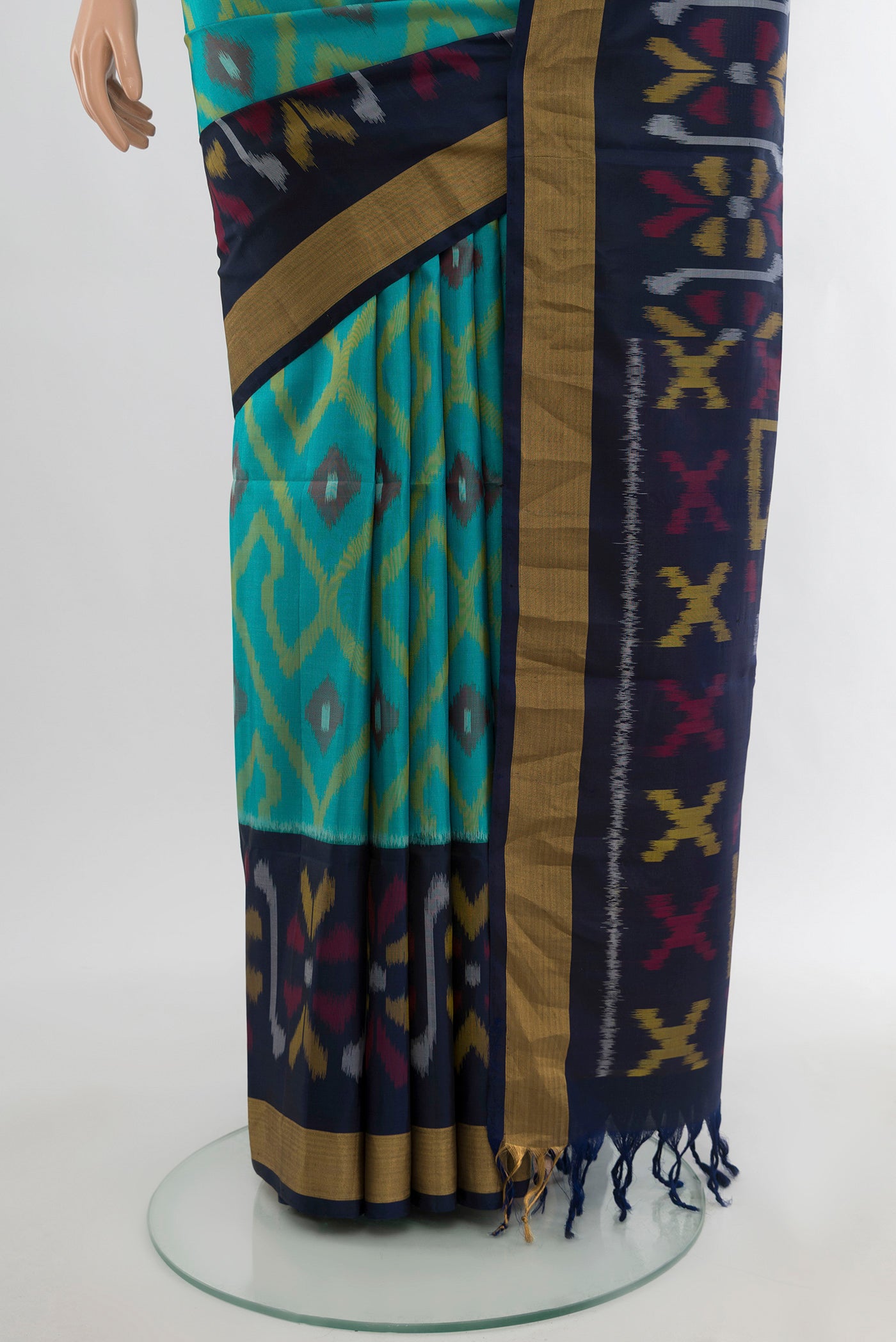 Pleats and pallu of Light Blue Soft Silk Saree with Ikat Print on the body and Zari Border. 