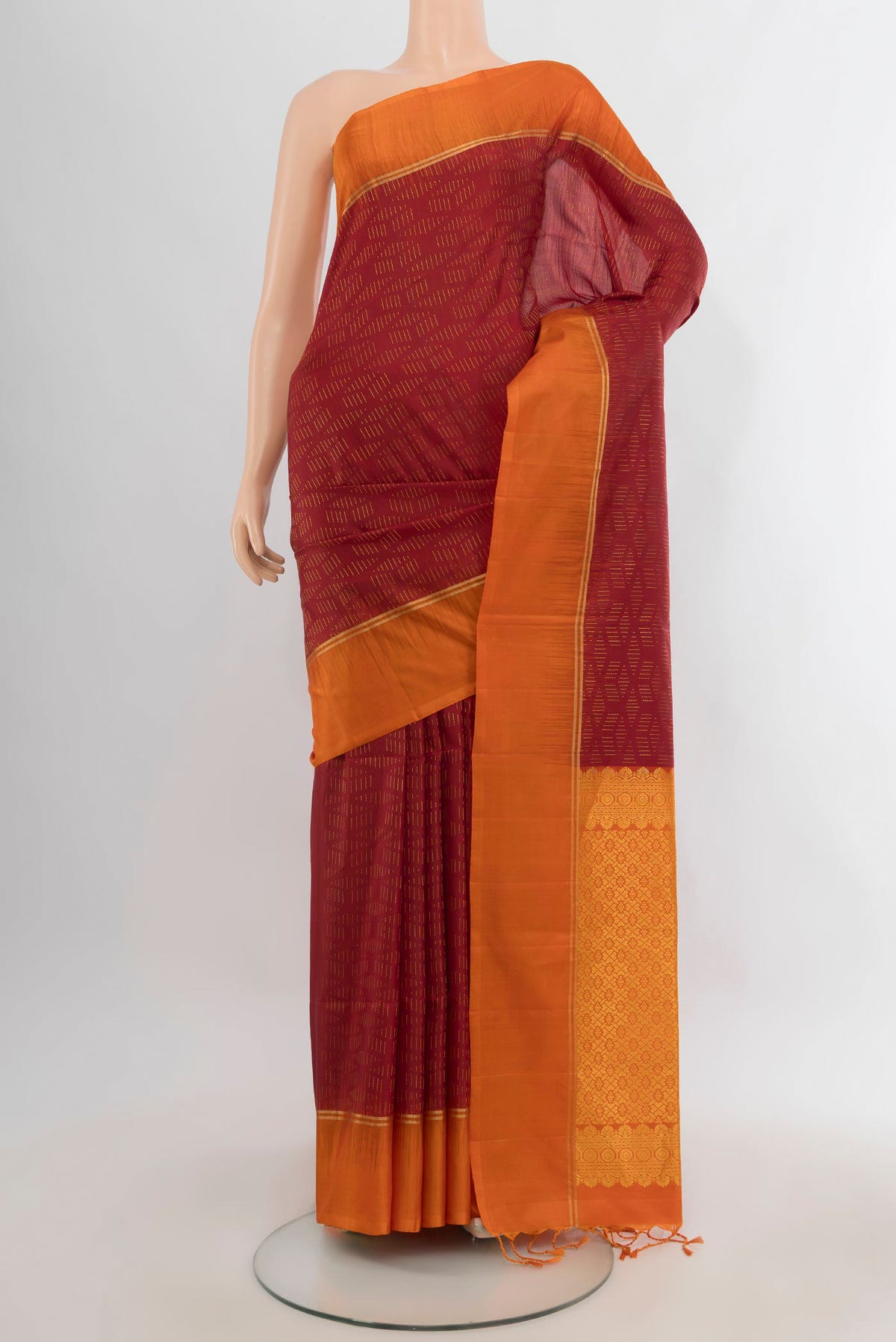Pure Silk Red Soft Saree with Zari Butta on the body and Plain Border.  displayed on a mannequin