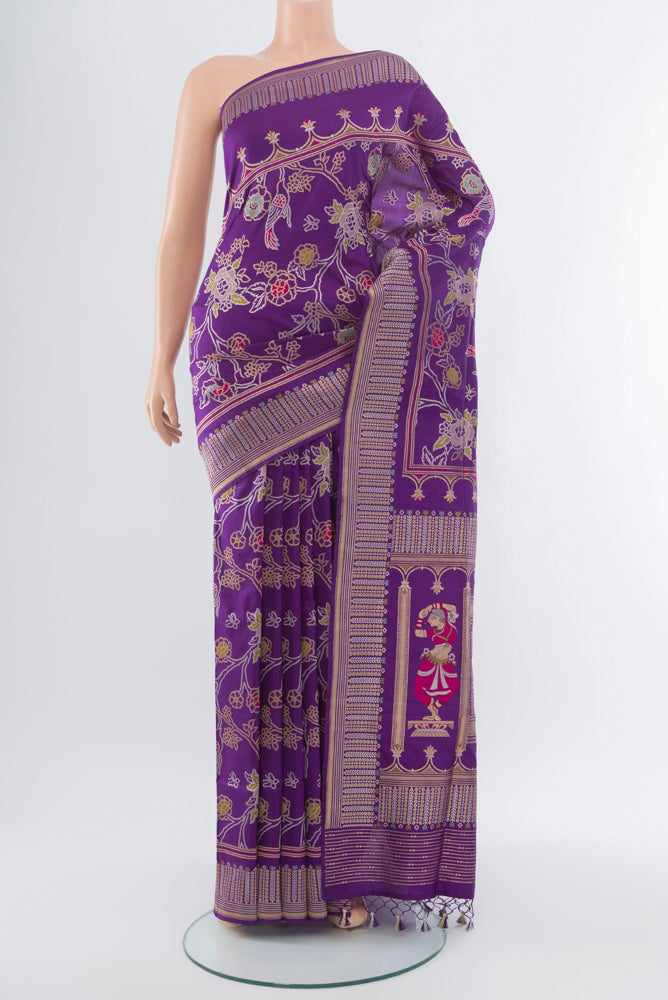Violet Banarasi Katan Silk Saree with Zari Butta on the body and Silk Border.  displayed on a mannequin