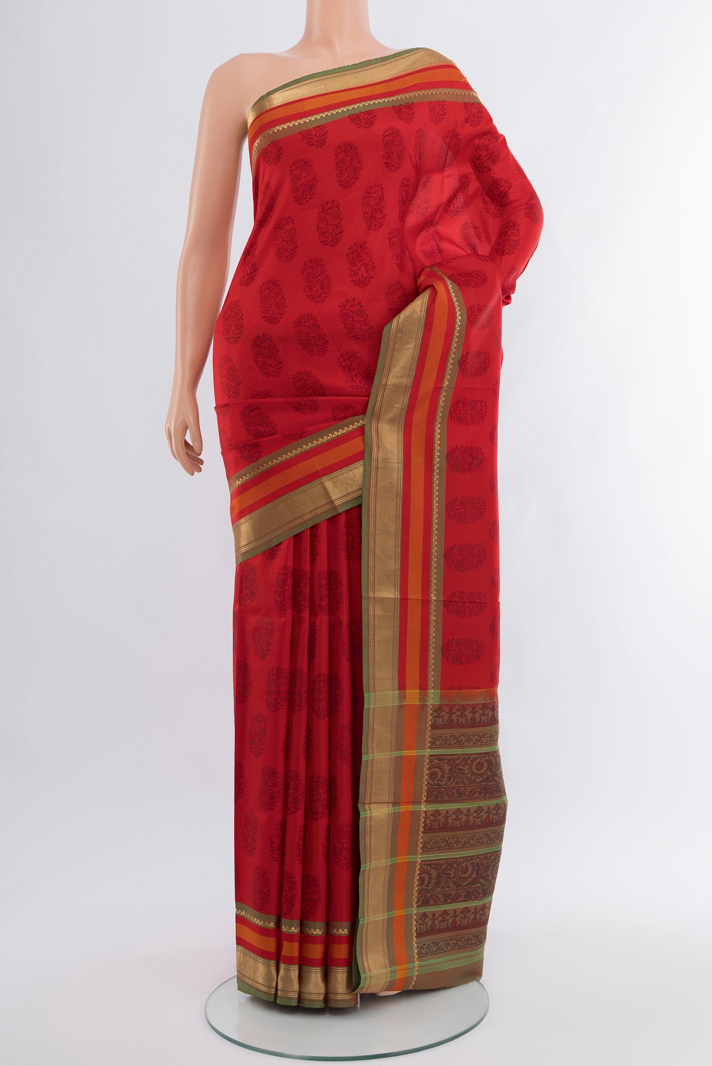 Red Printed Silk Saree with Floral Print on the body and Zari Border.  displayed on a mannequin