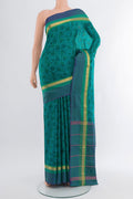 Peacock Blue Printed Silk Saree with Floral Print on the body and Zari Border.  displayed on a mannequin