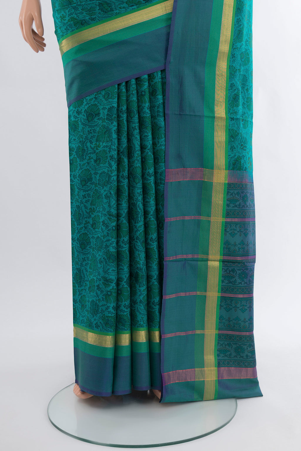 Pleats and pallu of Peacock Blue Printed Silk Saree with Floral Print on the body and Zari Border. 
