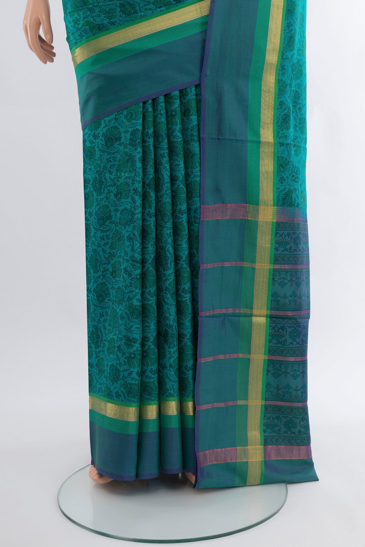 Pleats and pallu of Peacock Blue Printed Silk Saree with Floral Print on the body and Zari Border. 