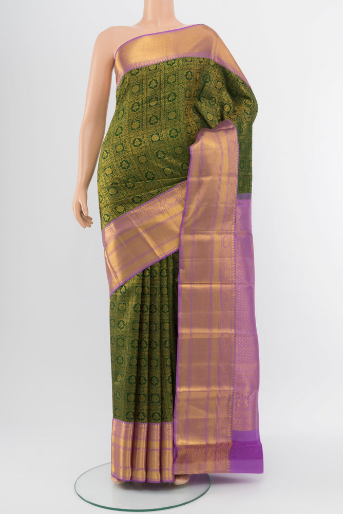 Mint Green Kanchipuram Silk Saree with Zari Butta on the body and Silk Border.  displayed on a mannequin