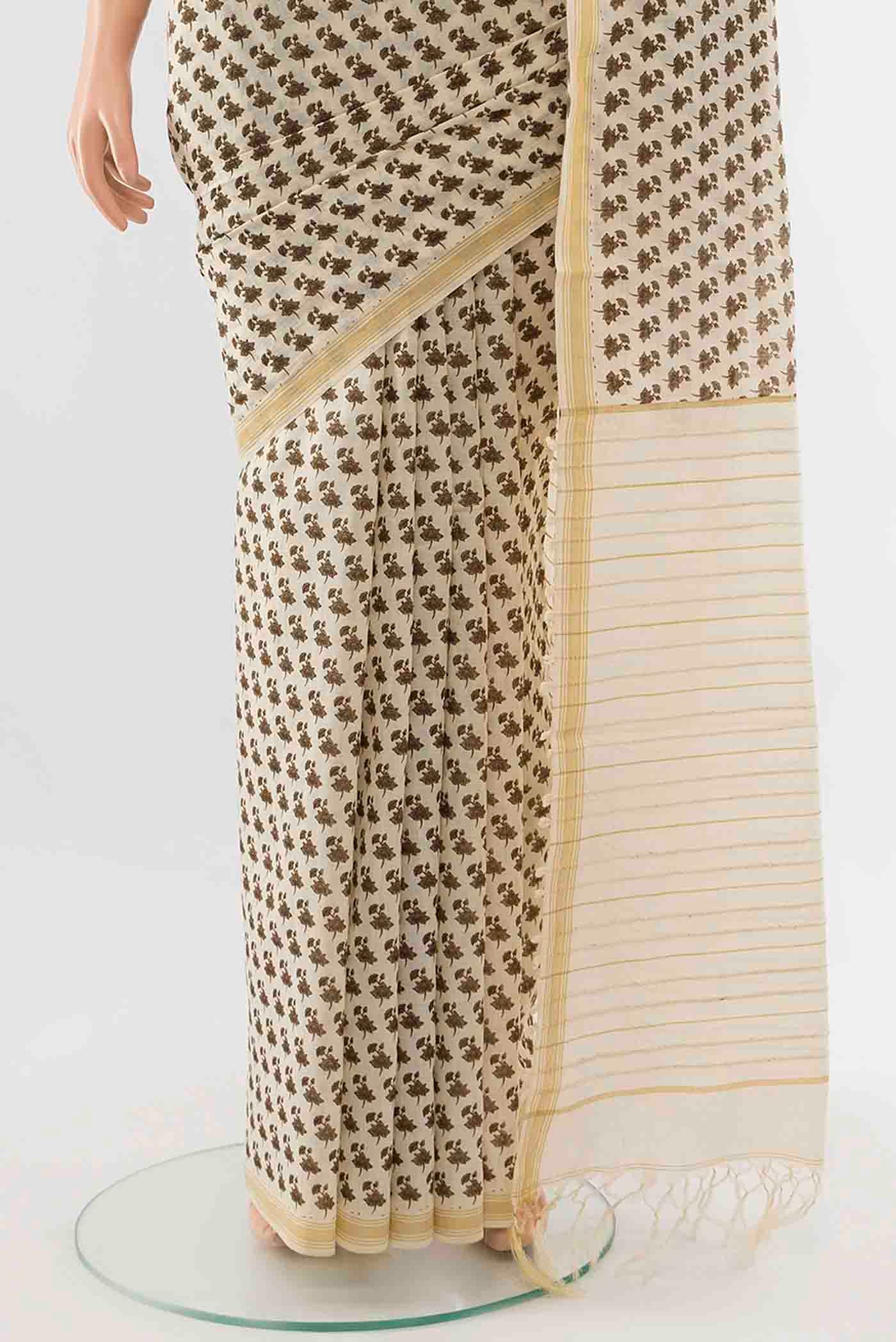 Pleats and pallu of Brown Tussar Silk Saree with Zari Butta on the body and Silk Border