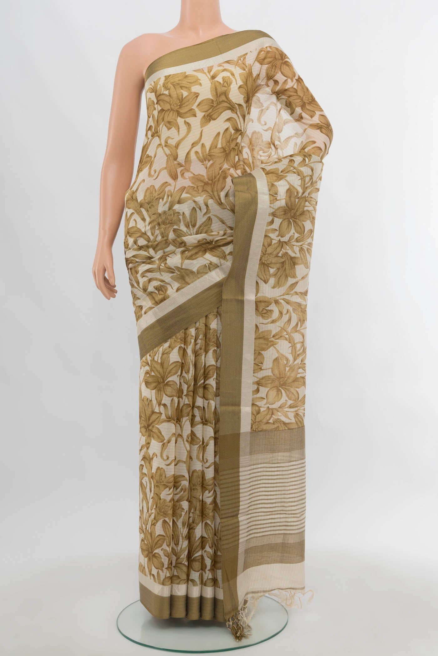 Light Green Maheshwari Silk Cotton Saree with Zari Butta on the body and Silk Border.  displayed on a mannequin