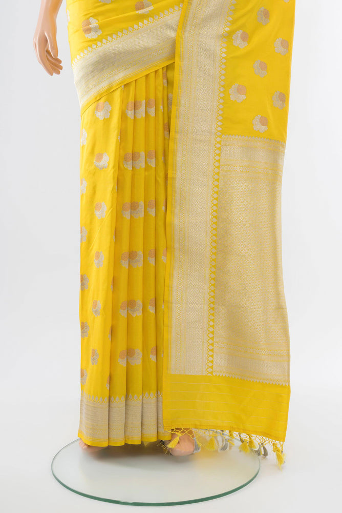 Pleats and pallu of Lemon Yellow Banarasi Katan Silk Saree with Zari Butta on the body and Silk Border. 