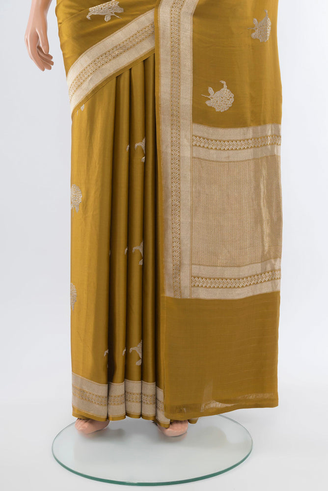 Pleats and pallu of Mehandi Green Banarasi Katan Silk Saree with Zari Butta on the body and Silk Border. 