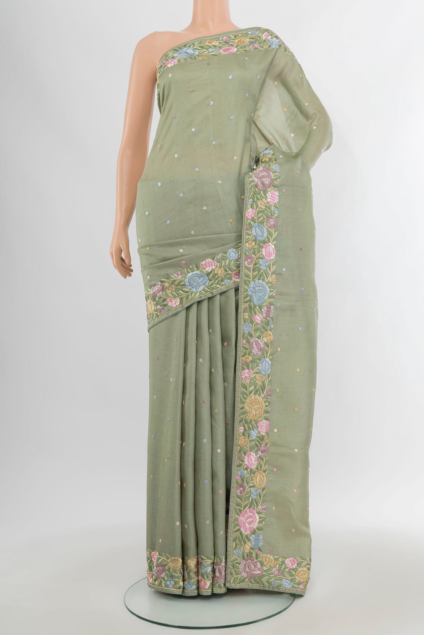 Pista Green Tussar Silk Saree with Embroidery on the body and Embroidery Border.  displayed on a mannequin