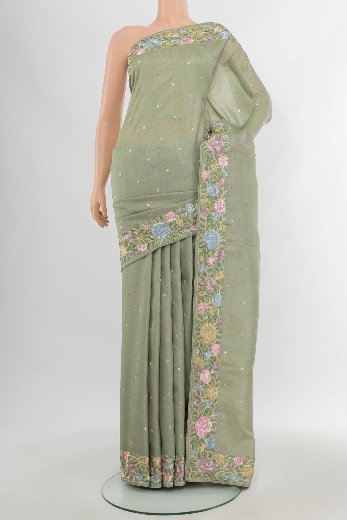 Pista Green Tussar Silk Saree with Embroidery on the body and Embroidery Border.  displayed on a mannequin