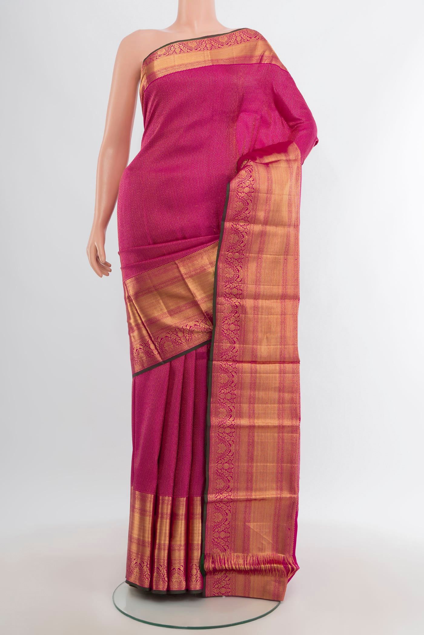 Magenta Kanchipuram Silk Saree with Zari Brocade on the body and Silk Border.  displayed on a mannequin