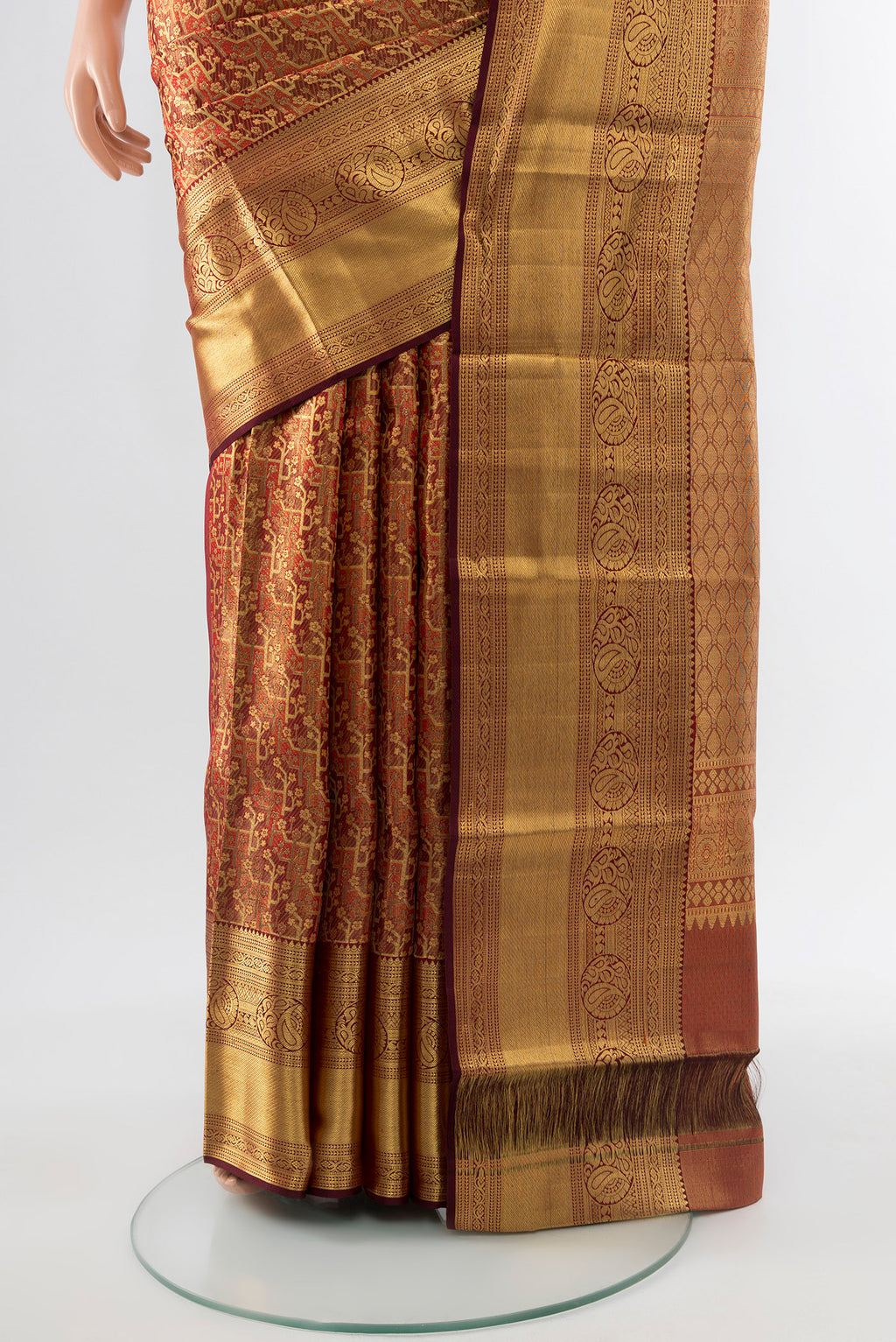 Pleats and pallu of Golden Kanchipuram Silk Saree with Zari Butta on the body and Silk Border. 