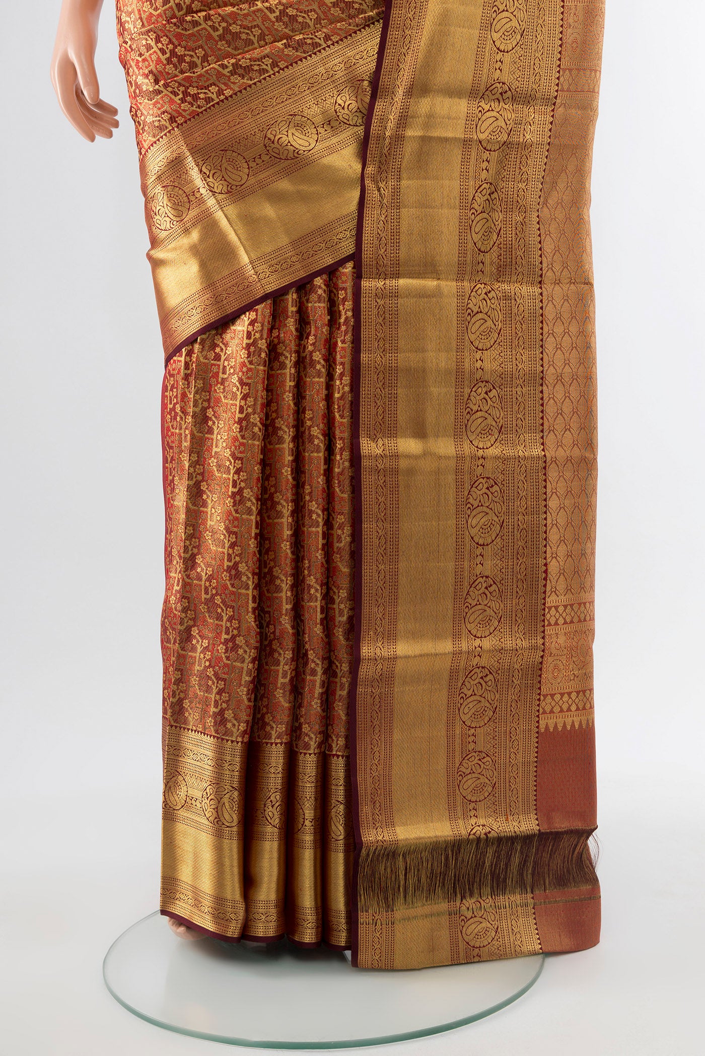 Pleats and pallu of Golden Kanchipuram Silk Saree with Zari Butta on the body and Silk Border. 