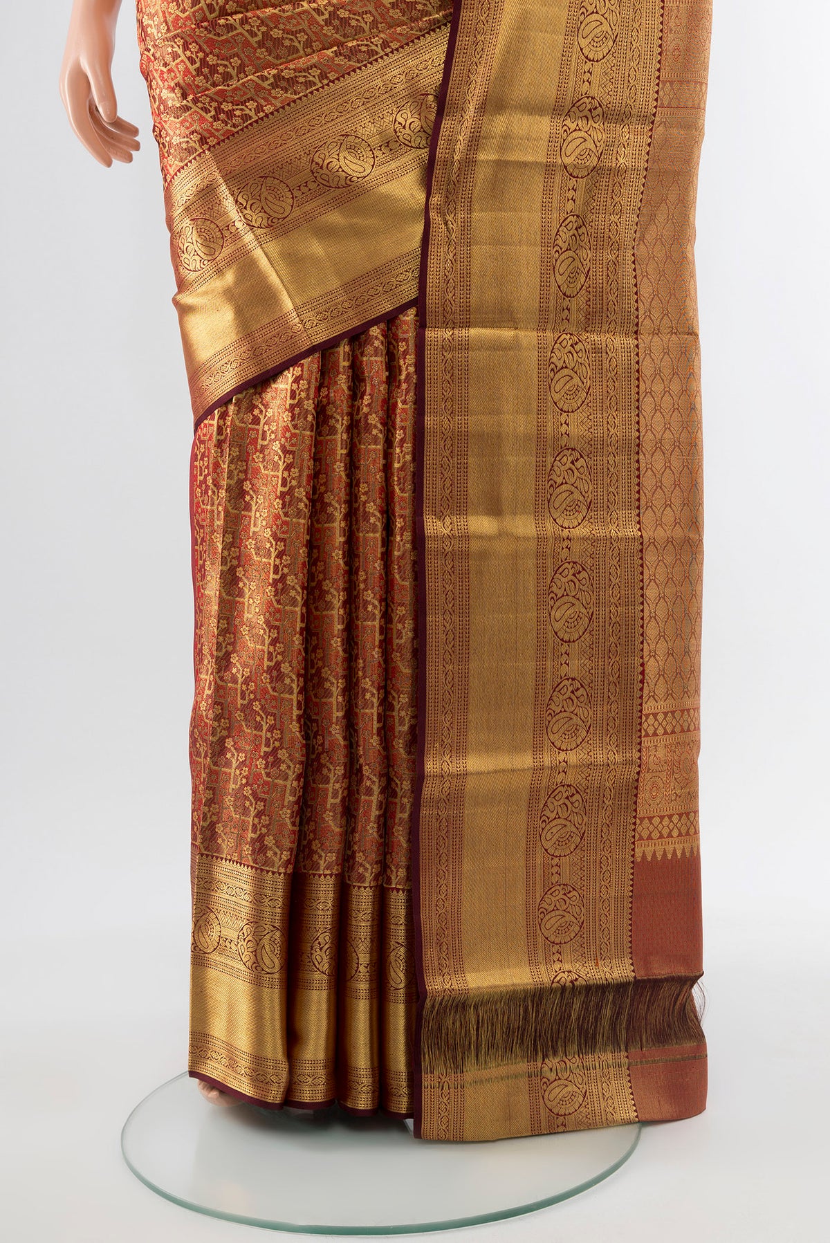 Pleats and pallu of Golden Kanchipuram Silk Saree with Zari Butta on the body and Silk Border. 