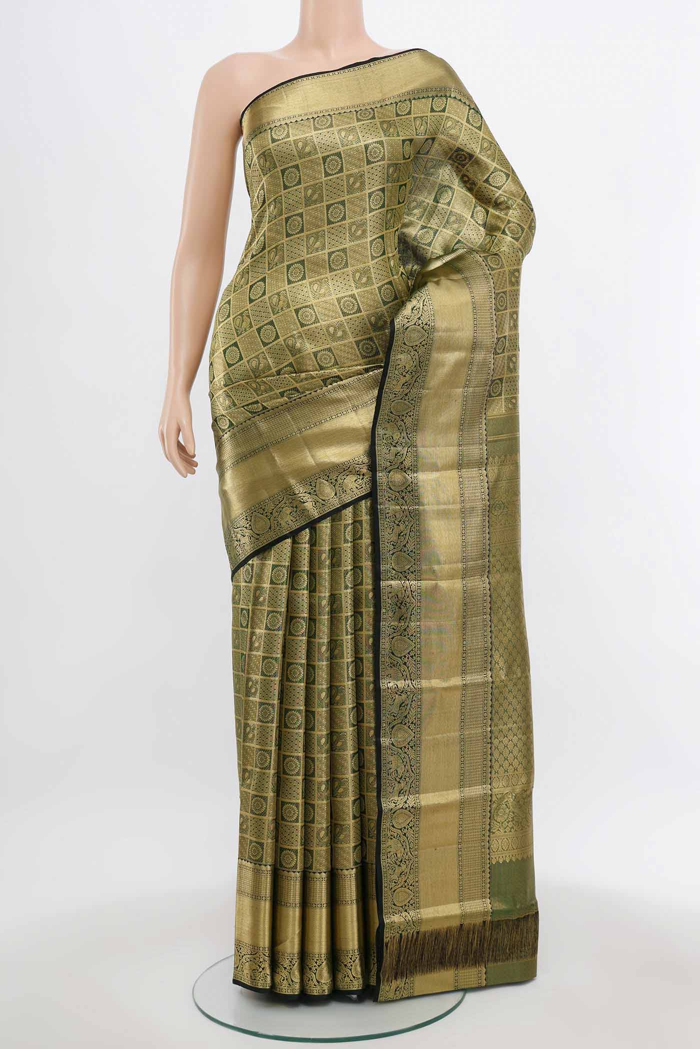 Golden Kanchipuram Silk Saree with Zari Butta on the body and Silk Border.  displayed on a mannequin