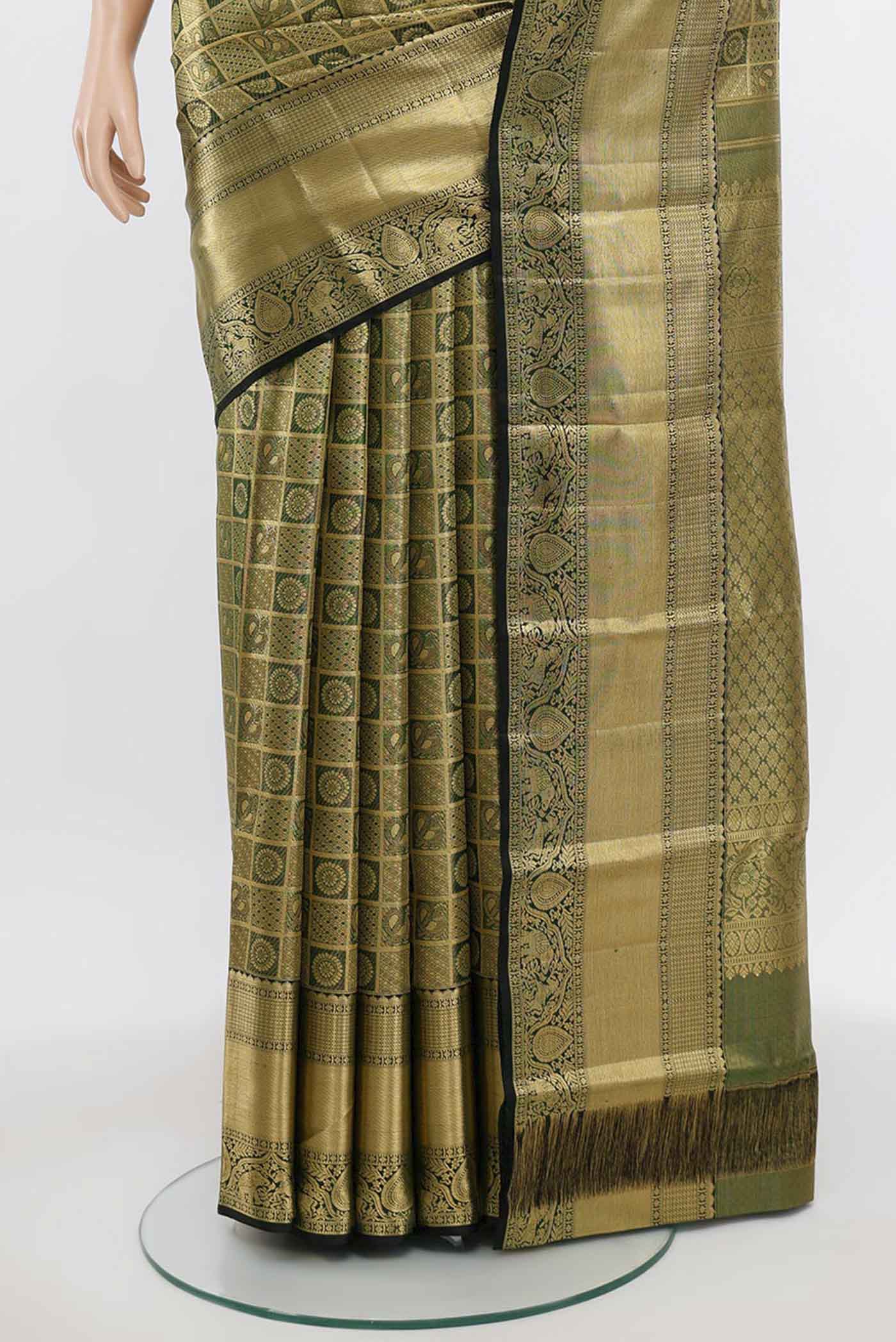 Pleats and pallu of Golden Kanchipuram Silk Saree with Zari Butta on the body and Silk Border. 
