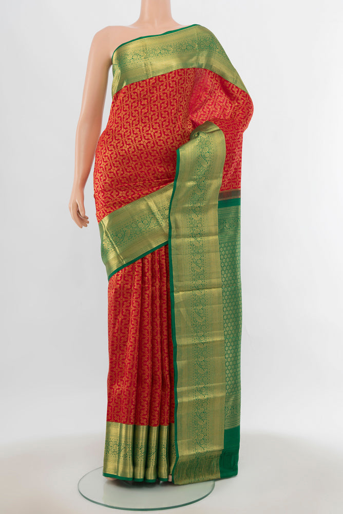 Red Kanchipuram Silk Saree with Zari Butta on the body and Silk Border.  displayed on a mannequin