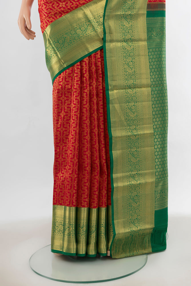 Pleats and pallu of Red Kanchipuram Silk Saree with Zari Butta on the body and Silk Border. 