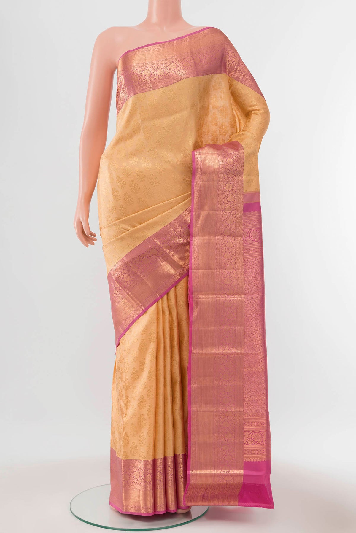 Rose Gold Kanchipuram Silk Saree with Zari Butta on the body and Silk Border displayed on a mannequin
