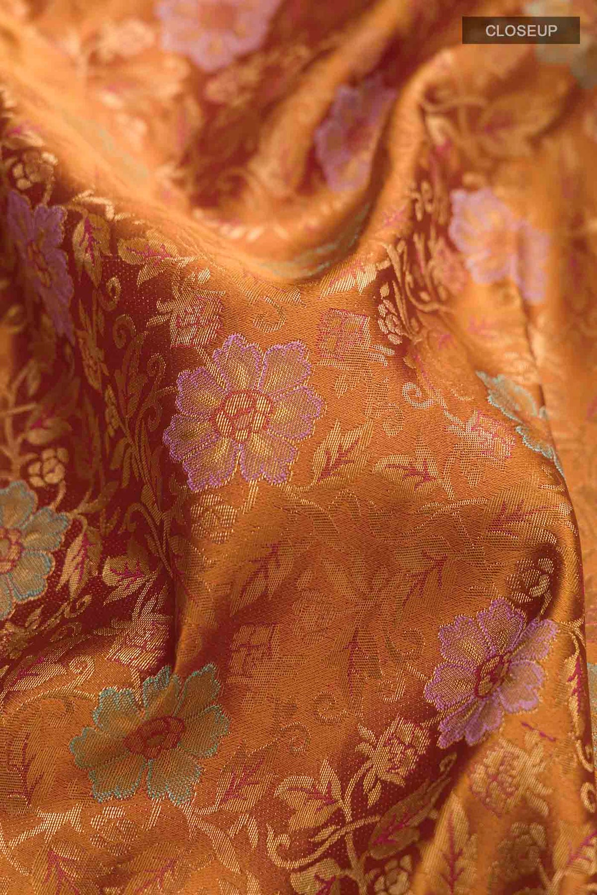 Close up of Mustard Kanchipuram Silk Saree with Zari Butta on the body and Zari Border displaying folds