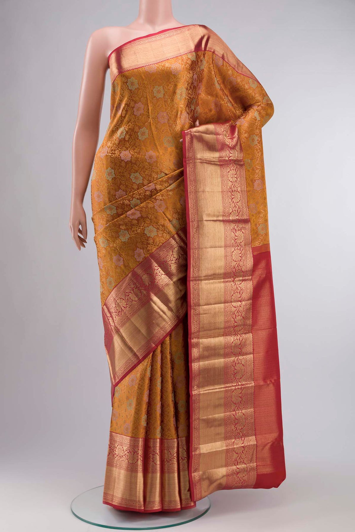 Mustard Kanchipuram Silk Saree with Zari Butta on the body and Zari Border displayed on a mannequin