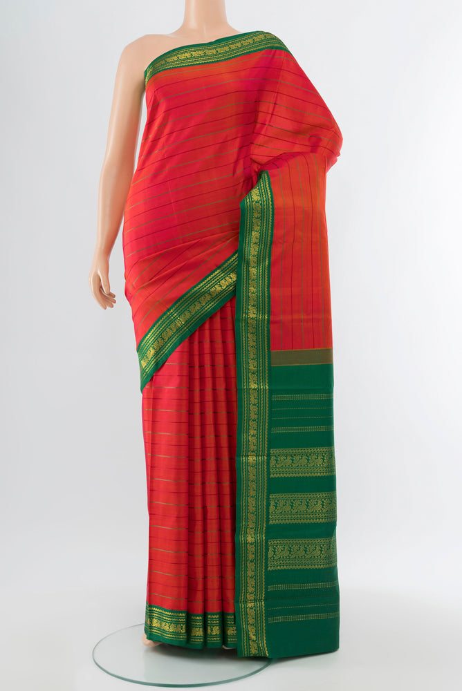 Pure Silk Pure Zari Peach Kanjivaram Saree with Zari Butta on the body and Silk Border.  displayed on a mannequin