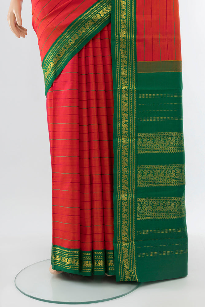 Pleats and pallu of Pure Silk Pure Zari Peach Kanjivaram Saree with Zari Butta on the body and Silk Border. 