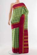 Light Green Kanjivaram Silk Saree with Zari Butta on the body and Silk Border.  displayed on a mannequin