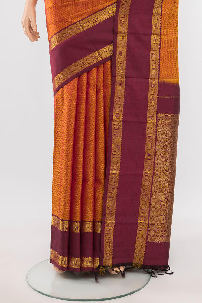 Pleats and pallu of Mustard Kanjivaram Silk Saree with Zari Butta on the body and Silk Border. 