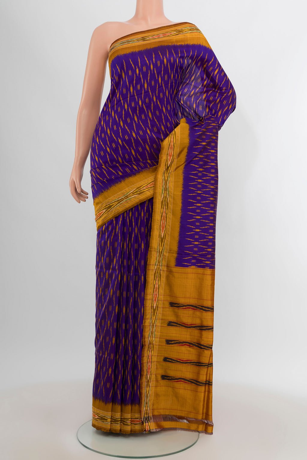 Violet Pochampally Silk Saree with Ikat design on the body and Zari Border.  displayed on a mannequin
