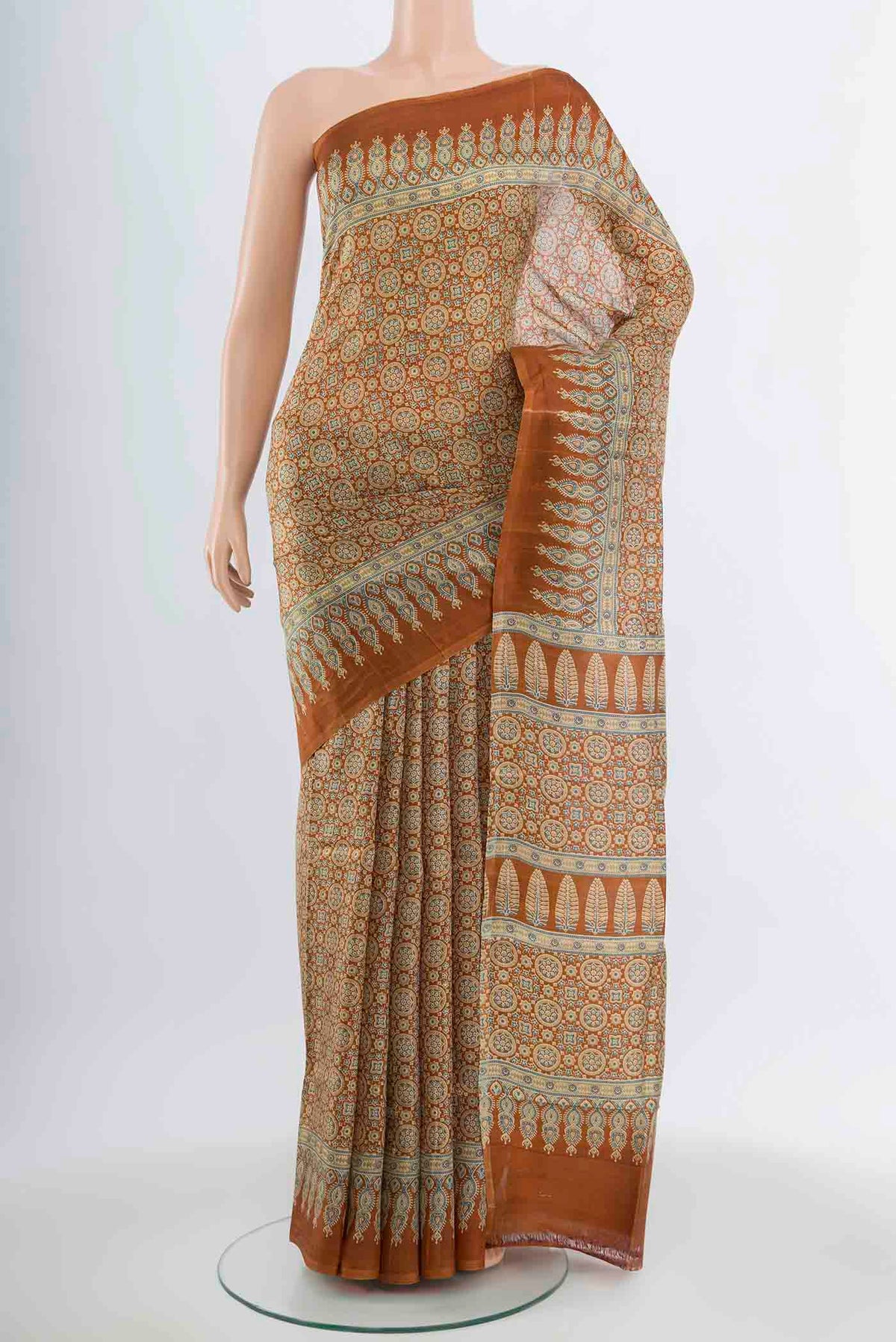 Brown Tussar Silk Saree with Floral Print on the body and Silk Border.  displayed on a mannequin