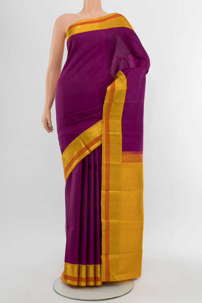 Purple Kanjivaram Silk Saree with Plain Body and Silk Border.  displayed on a mannequin