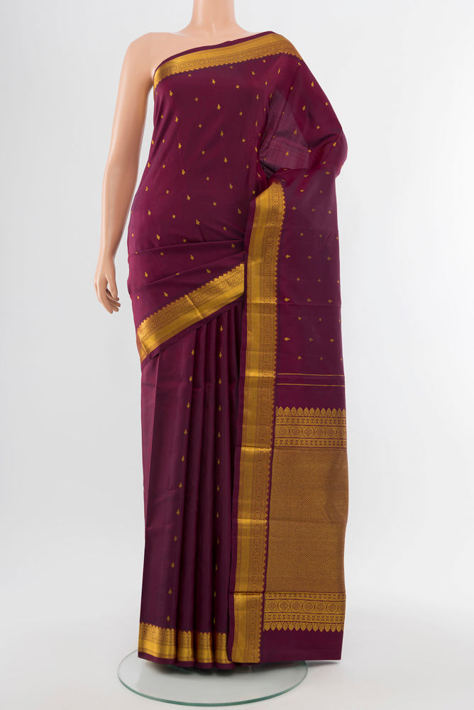 Coffee Brown Kanchipuram Silk Saree with Zari Butta on the body and Silk Border.  displayed on a mannequin