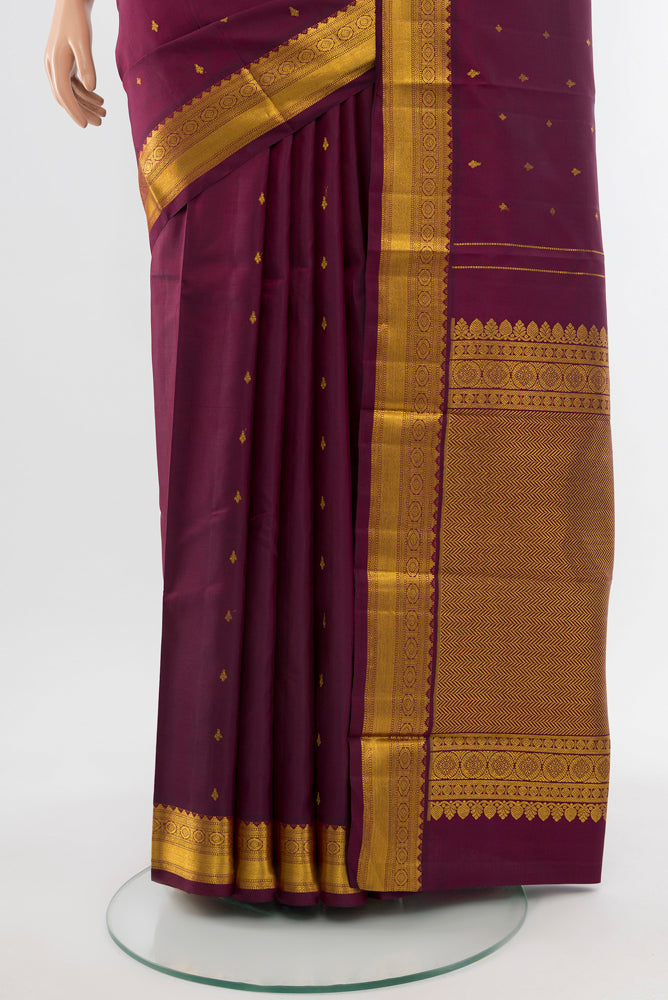 Pleats and pallu of Coffee Brown Kanchipuram Silk Saree with Zari Butta on the body and Silk Border. 