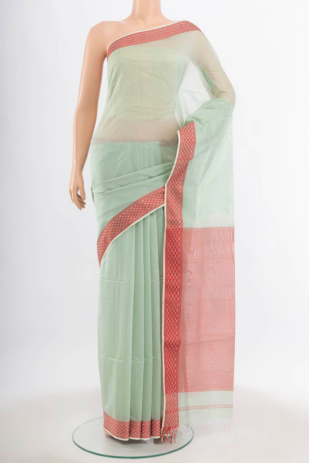 Pista Green Maheshwari Silk Cotton Saree with Zari Butta on the body and Silk Border.  displayed on a mannequin